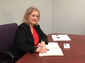 New Brunswick voters head to the polls Monday in a provincial election, but the woman in charge of the entire electoral process, and encouraging more people to vote, won't be casting a ballot -- she's not allowed to. New Brunswick Chief Electoral officer Kimberly Poffenroth poses as she signs the writs for the Sept. 24 provincial election in Fredericton on Wednesday, Aug. 22, 2018.