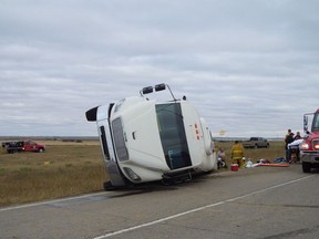 A bus sits on its side after an accident with a semi-truck near Kerrobert, Sask., on Friday Sept. 14, 2018.