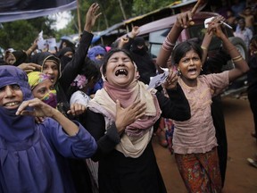 Rohingya women cry as they shout slogans during a protest rally to commemorate the first anniversary of Myanmar army's crackdown which lead to a mass exodus of Rohingya Muslims to Bangladesh, at Kutupalong refugee camp in Bangladesh, Saturday, Aug. 25, 2018. Rohingya women and girls who survived the genocide of their people in Myanmar are facing ongoing risks to their protection and health in refugee camps in Bangladesh, according to a new report from Oxfam Canada.