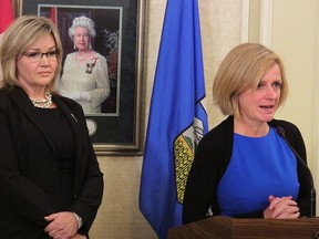 Sandra Jansen, a former Progressive Conservative leadership contender and new infrastructure minister looks on as NDP Premier Rachel Notley speaks at Government House in Edmonton after Jansen was sworn in, on Tuesday, October17, 2017. The Alberta government is looking for a new builder for the Grande Prairie Regional Hospital. Infrastructure Minister Sandra Jansen says it has terminated the contract with the current builder, Calgary-based Graham Construction.