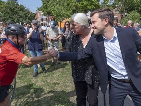Quebec Solidaire co-spokesperson Gabriel Nadeau-Dubois and Manon Masse greet supporters as they arrive to launch their campaign in Montreal on Thursday, August 23, 2018.