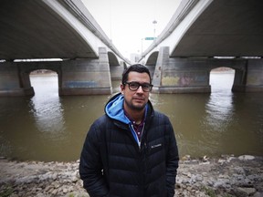 David Alexander Robertson, author of "Betty: The Helen Betty Osborne Story," is photographed beside Winnipeg's Red River, Wednesday, November 11, 2015. Edmonton Public Schools says it's taking down its book review site after a leading Indigenous author questioned why his graphic novels were on a not-recommended list.