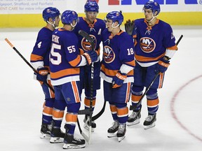 New York Islanders players celebrate a goal by Anthony Beauvillier (18) during the first period of a preseason NHL hockey game against the New York Rangers, Saturday, Sept. 22, 2018, in Bridgeport, Conn.