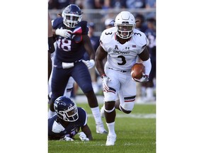 Cincinnati running back Michael Warren II (3) gains yardage during the first half of an NCAA college football game against Connecticut, Saturday, Sept. 29, 2018, in East Hartford, Conn.