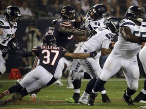 Seattle Seahawks quarterback Russell Wilson (3) gets sacked by Chicago Bears linebacker Aaron Lynch (99) as he is pressured by Lynch and cornerback Bryce Callahan (37) during the first half of an NFL football game Monday, Sept. 17, 2018, in Chicago.