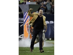 Former Chicago Bears and Hall of Fame linebacker Brian Urlacher runs to the field for a Ring of Excellence ceremony by the Bears during the halftime of an NFL football game Monday, Sept. 17, 2018, in Chicago.