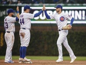 Chicago Cubs' Anthony Rizzo, center, celebrates with Kris Bryant, right, after the Cubs defeated the St. Louis Cardinals 8-4 in a baseball game, Friday, Sept. 28, 2018, in Chicago.