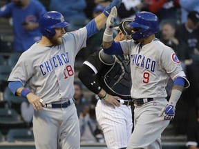 Chicago Cubs' Javier Baez, right, celebrates with Ben Zobrist after hitting a two-run home run against the Chicago White Sox during the first inning of a baseball game Saturday, Sept. 22, 2018, in Chicago.
