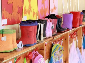 Rainboots and backpacks line the side of a colourfully painted daycare classroom.  Police report that five people, including three infants, have been stabbed at a New York daycare centre.