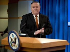 Secretary of State Mike Pompeo arrives to speak at a news conference in the press briefing room at the State Department in Washington, Friday, Sept. 14, 2018, in Washington. Pompeo says his Obama-era predecessor John Kerry has been 'actively undermining' U.S. policy on Iran.