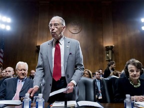 Senate Judiciary Committee Chairman Chuck Grassley, R-Iowa, center, accompanied by and Sen. Dianne Feinstein, D-Calif., the ranking member, right, and Sen. Orrin Hatch, R-Utah, gavels the start of a Senate Judiciary Committee markup meeting on Capitol Hill, Thursday, Sept. 13, 2018, in Washington. The committee will vote next week on whether to recommend President Donald Trump's Supreme Court nominee, Brett Kavanaugh for confirmation. Republicans hope to confirm him to the court by Oct. 1.