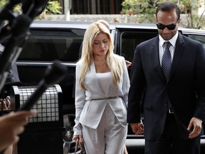 Former Donald Trump presidential campaign foreign policy adviser George Papadopoulos, right, who pleaded guilty to one count of making false statements to the FBI during the agency's Russia probe, holds hands with his wife Simona Mangiante, as they arrive at federal court for sentencing, Friday, Sept. 7, 2018, in Washington.
