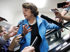 Sen. Dianne Feinstein, D-Calif., is surrounded by reporters as she arrives for a vote, Tuesday, Sept. 18, 2018, on Capitol Hill in Washington.