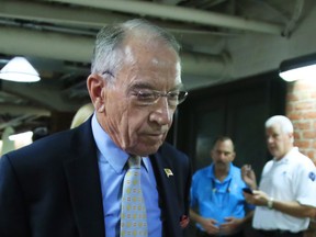 Senate Judiciary Committee Chairman Sen. Chuck Grassley, R-Iowa, walks through a tunnel towards the Dirksen Senate Building on Capitol Hill in Washington, Wednesday, Sept. 19, 2018. Grassley had set a Friday night deadline for the 51-year-old California psychology professor to agree to the latest offer setting terms for Ford's appearance.