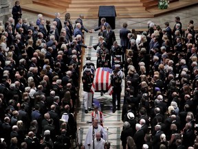 The family of Sen. John McCain, R-Ariz., follows as his casket is carried at the end of a memorial service at Washington National Cathedral in Washington, Saturday, Sept. 1, 2018. McCain died Aug. 25, from brain cancer at age 81.