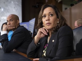 Sen. Kamala Harris, D-Calif., and Sen. Cory Booker, D-N.J., left, pause as protesters disrupt the confirmation hearing of President Donald Trump's Supreme Court nominee, Brett Kavanaugh, on Capitol Hill in Washington, Tuesday, Sept. 4, 2018.