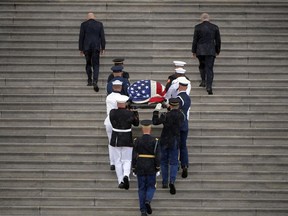 The flag-draped casket of Sen. John McCain, R-Ariz., is carried up the steps of the U.S. Capitol, Friday, Aug. 31, 2018, in Washington.