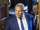 Ontario Premier Doug Ford looks into the chamber during an interruption by hecklers during the morning session in the legislature at Queen's Park in Toronto, Sept. 12, 2018.