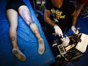 A tattoo artist tattooes a visitor at the fourth edition of the Montreux Tattoo Convention in Montreux, Switzerland, Saturday, Sept. 22, 2018. Over 150 tattoo artists from 22 couttries gather for 3 days in Montreux.