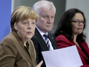 FILE -- In this Thursday, April 14, 2016 photo, from left, German Chancellor Angela Merkel, Horst Seehofer, Chairman of the German Christian Social Union and Andrea Nahles, Chairwomen of the German Social Democrats, address the media during a press conference in Berlin. The leaders of German Chancellor Angela Merkel's governing coalition were trying Sunday to resolve a standoff over the future of the country's domestic intelligence chief and stabilize their six-month-old alliance.