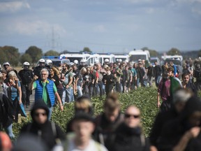 Protesters are observed by the Police as they try to enter the Hambach forest in Kerpen, Germany, Satrurday, Sept. 15, 2018. German energy company RWE plans clearing and grubbing the forest for their open-pit lignite mine nearby to continue digging for brown coal.