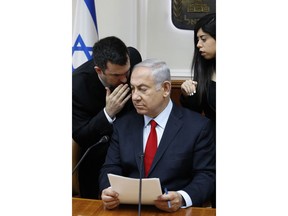 FILE - In this July 23, 2018 file photo, Israeli Prime Minister Benjamin Netanyahu listens to his spokesman David Keyes as he opens the weekly cabinet meeting at his Jerusalem office. An opposition Israeli lawmaker is calling on Netanyahu to suspend Keyes following sexual assault allegations. Michal Rozin, a legislator with the dovish Meretz party, says David Keyes, Netanyahu's spokesman to the foreign media, can no longer represent Israel to the world amid the accusations.