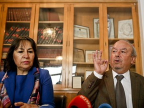 Rodolfo Reyes, right, nephew of the late poet Pablo Neruda, gives a press conference alongside lawyer Elisabeth Flores in Santiago, Chile, Thursday, Sept. 6, 2018. Reyes says that money owed by Chile to laboratories abroad is blocking final tests to determine the cause of death of the Nobel Prize-winning poet. The leftist  writer died in the chaos following Chile's 1973 right-wing military coup. The official version was that he died of cancer. Some have speculated that he was poisoned.