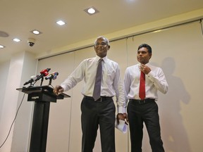 Maldives' opposition presidential candidate Ibrahim Mohamed Solih, left, and his running mate, Faisal Naseem, leave after addressing media in Male, Maldives, Monday, Sept. 24, 2018. A longtime but little-known lawmaker, Solih declared victory at his party's campaign headquarters in a contentious election widely seen as a referendum on the island nation's young democracy.