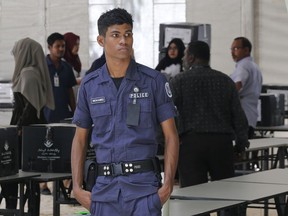 A Maldivian police officer stands guard at the main election material distribution center in Male, Maldives, Saturday, Sept. 22, 2018. Maldivians will go to the polls on Sunday.