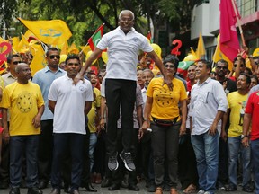 Maldives' opposition presidential candidate Ibrahim Mohamed Solih, center, jumps as he walks in a street march with supporters in Male, Maldives, Saturday, Sept. 22, 2018. Solih, the only contender in Sunday's election against incumbent President Yameen Abdul Gayoom, is backed by former President Mohamed Nasheed who is now living in exile in neighboring Sri Lanka.