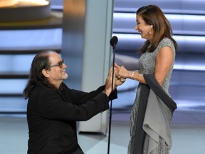 Glenn Weiss  (L), winner of the Outstanding Directing for a Variety Special award for 'The Oscars,' proposes marriage to Jan Svendsen onstage during the 70th Emmy Awards at Microsoft Theater on September 17, 2018 in Los Angeles, California.