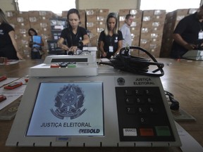 Employees of the Regional Electoral Tribunal work on the preparation of the electoral urns, during a public sealing, in Brasilia, Brazil Wednesday, Sept. 19, 2018. Brazilian electoral justice will use 600,000 urns in the first round of Brazilian general elections, on October 7.