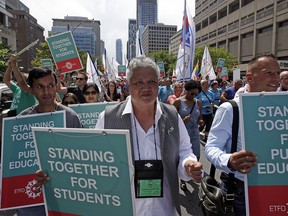 Ontario elementary school teachers and supporters protest a rollback in the province's sex-ed curriculum, in Toronto on Aug. 14, 2018.
