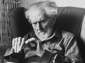 Poet Ezra Pound, 95, relaxing in wing chair in apartment.