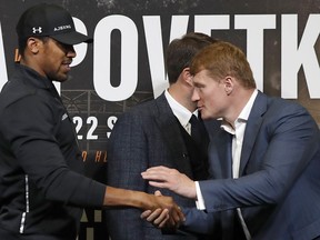 Boxers, Britain's Anthony Joshua, left, and Russia's Alexander Povetkin shake hands before a press conference at Wembley stadium in London, Thursday, Sept. 20, 2018. Joshua and Povetkin are due to fight for the WBA, IBF, WBO and IBO heavyweight title in a boxing match on Saturday at Wembley stadium.