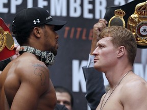Britain's Anthony Joshua, left, and Russia's Alexander Povetkin pose during the weigh-in at the Business Design Centre in London, Friday, Sept. 21, 2018. Anthony Joshua and Alexander Povetkin are due to fight for the WBA, IBF, WBO and IBO heavyweight title in a boxing match on Saturday Sept. 22, 2018 at Wembley stadium.