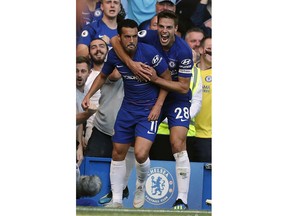 Chelsea's Pedro, left, celebrates with Chelsea's Cesar Azpilicueta after scoring his side's first goal during the English Premier League soccer match between Chelsea and Bournemouth at Stamford Bridge stadium in London, Saturday, Sept. 1, 2018.