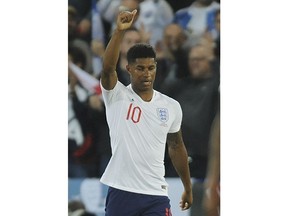 England's Marcus Rashford celebrates after scoring his side's first goal during the International friendly soccer match between England and Switzerland at the King Power Stadium in Leicester, England, Tuesday, Sept. 11, 2018 .