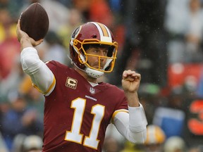 Washington Redskins quarterback Alex Smith (11) passes the ball during the first half of an NFL football game against the Green Bay Packers, Sunday, Sept. 23, 2018, in Landover, Md.