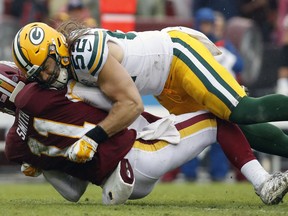 Green Bay Packers linebacker Clay Matthews (52) hits Washington Redskins quarterback Alex Smith (11) during the second half of an NFL football game, Sunday, Sept. 23, 2018 in Landover, Md.