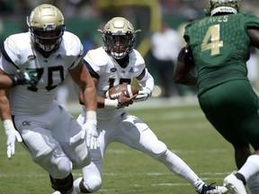 Georgia Tech quarterback TaQuon Marshall (16) looks for room to run during the first quarter of an NCAA football game against the South Florida, Saturday, Sept. 8, 2018, in Tampa, Fla.