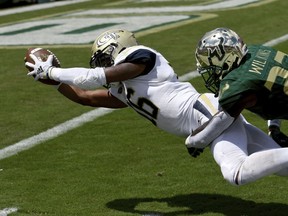 South Florida cornerback Mazzi Wilkins (23) can't stop Georgia Tech quarterback TaQuon Marshall (16) as he dives into the end zone for a touchdown during the first quarter of an NCAA football game Saturday, Sept. 8, 2018, in Tampa, Fla.