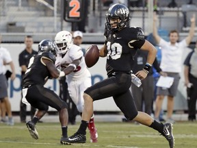 Central Florida quarterback McKenzie Milton (10) runs for a 12-yard touchdown against Florida Atlantic during the first half of an NCAA college football game, Friday, Sept. 21, 2018, in Orlando, Fla.