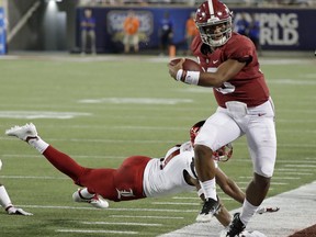 Alabama quarterback Tua Tagovailoa, right, is forced out of bounds by Louisville safety Dee Smith after a short gain during the first half of an NCAA college football game Saturday, Sept. 1, 2018, in Orlando, Fla.