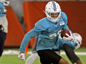 FILE - In this Aug. 28, 2018 file photo, Miami Dolphins safety Minkah Fitzpatrick runs a drill during NFL football training camp in Davie, Fla. The Dolphins rookie safety wants to trademark his nickname but says he'd be happy to share it with Tampa Bay Buccaneers quarterback Ryan Fitzpatrick. Both go by "FitzMagic.