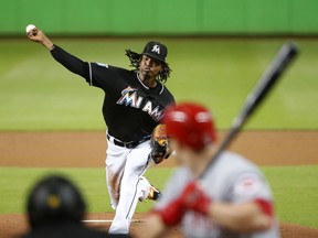 Miami Marlins' Jose Urena pitches to Cincinnati Reds' Scott Schebler during the first inning of a baseball game, Saturday, Sept. 22, 2018, in Miami.