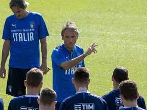 Italy coach Roberto Mancini, center, talks to his players during a training session at the Coverciano Sports Center, in Florence, Italy, Thursday, Sept. 46 2018. Italy will play Poland in a UEFA Nations League soccer match on Friday in Bologna.