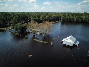 A flooded farm stands next to the Lumber River in this aerial photograph taken after Hurricane Florence on Sept. 17, 2018. MUST CREDIT: Charles Mostoller/Bloomberg