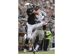 Central Florida wide receiver Tre Nixon, left, catches a pass over South Carolina State defensive back Alex Brown (30) for a 38-yard gain during the first half of an NCAA college football game Saturday, Sept. 8, 2018, in Orlando, Fla.