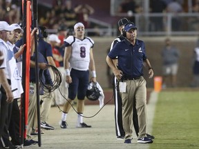 Samford coach Chris Hatcher talks on his headset as walks the sideline in the first quarter of an NCAA college football game with Florida State, Saturday, Sept. 8, 2018, in Tallahassee Fla. Florida State won 36-26.